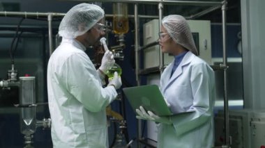 Two scientist in professional uniform working in curative laboratory for chemical and biomedical experiment