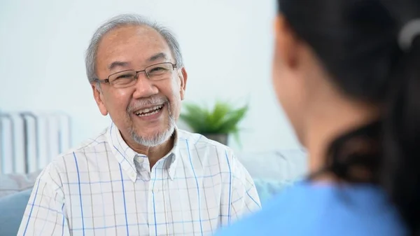 Young Female Doctor Inquires Personal Information Contented Senior Home Medical — Stock fotografie