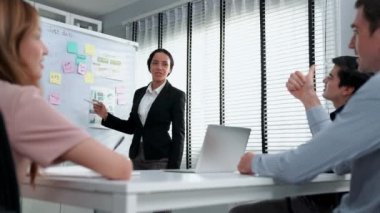 Competent office workers from various nationalities are debating, discussing and brainstorming in the meeting room. A group of employees is collaborating to achieve their business objectives.