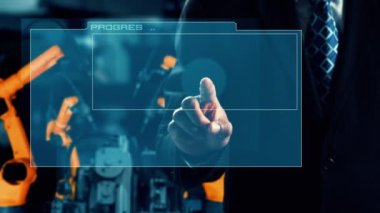 Engineer use cybernated robotic software to control industry robot arm in factory . Automation manufacturing process controlled by specialist using IOT software connected to internet network .