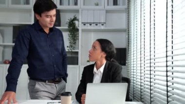 Concept of experienced and competent coworker, employer, supervisor giving advice to a young female office worker. Teamwork between coworkers, leadership company, multiracial in workspace.