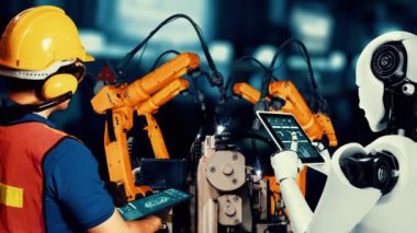 Cybernated industry robot and human worker working together in future factory . Concept of artificial intelligence for industrial revolution and automation manufacturing process .