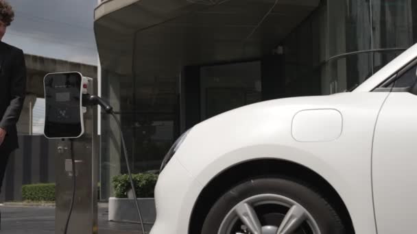 Progressive Businessman Install Charger Plug Charging Station His Electric Car — Stock Video