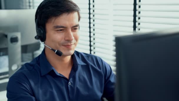 Young Competent Asian Male Call Center Agent Working His Computer — Stock video