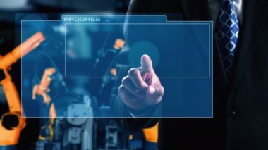 Engineer use cybernated robotic software to control industry robot arm in factory . Automation manufacturing process controlled by specialist using IOT software connected to internet network .