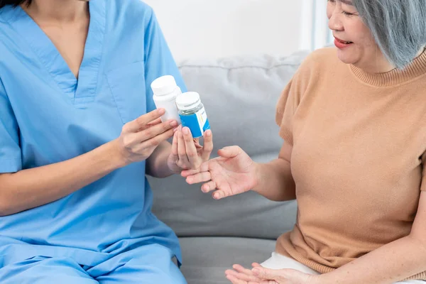 Caregiver Advising Contented Senior Woman Medication Living Room Medication Seniors — Foto de Stock