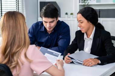 A young female asian candidate tries to impress her interviewer by being competent. International company, multicultural environment in workplace.