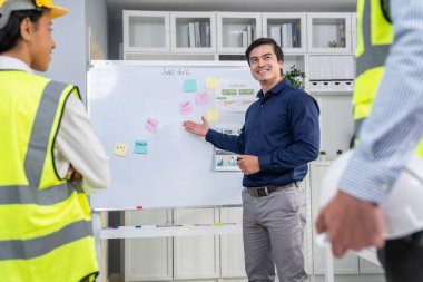 Entrepreneur brainstorming ideas with his competent engineers in the office. Architectural investors and engineers working on an upcoming project in a fun and friendly environment.